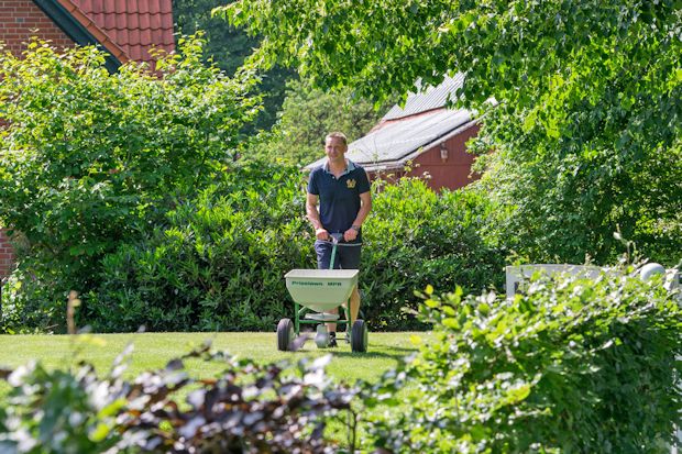 Mit Rasendünger, der gleich mehrere Anwendungen in sich vereint, kann man viel Zeit sparen.